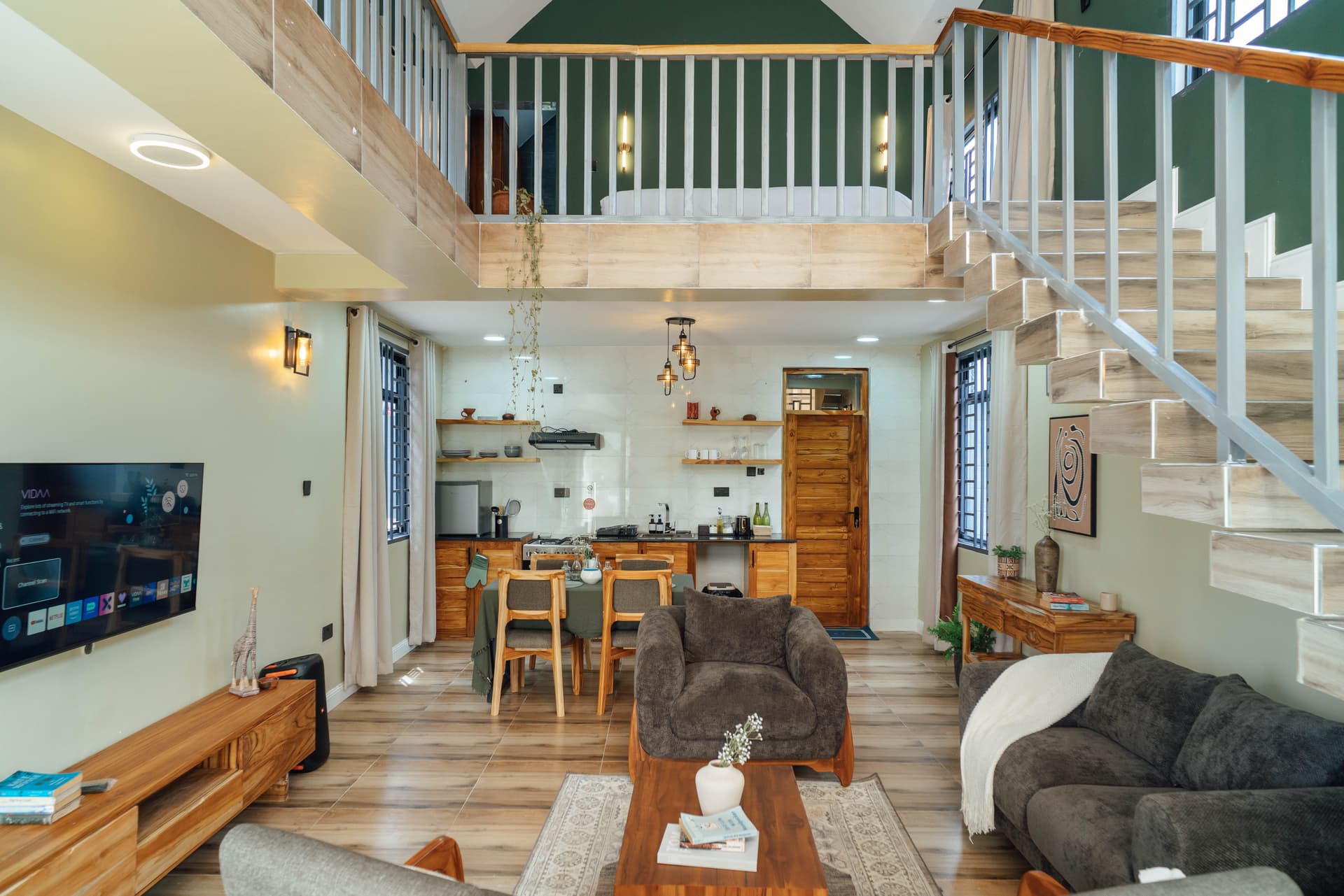 Acacia Loft living room with mezzanine bedroom at Starico Residence